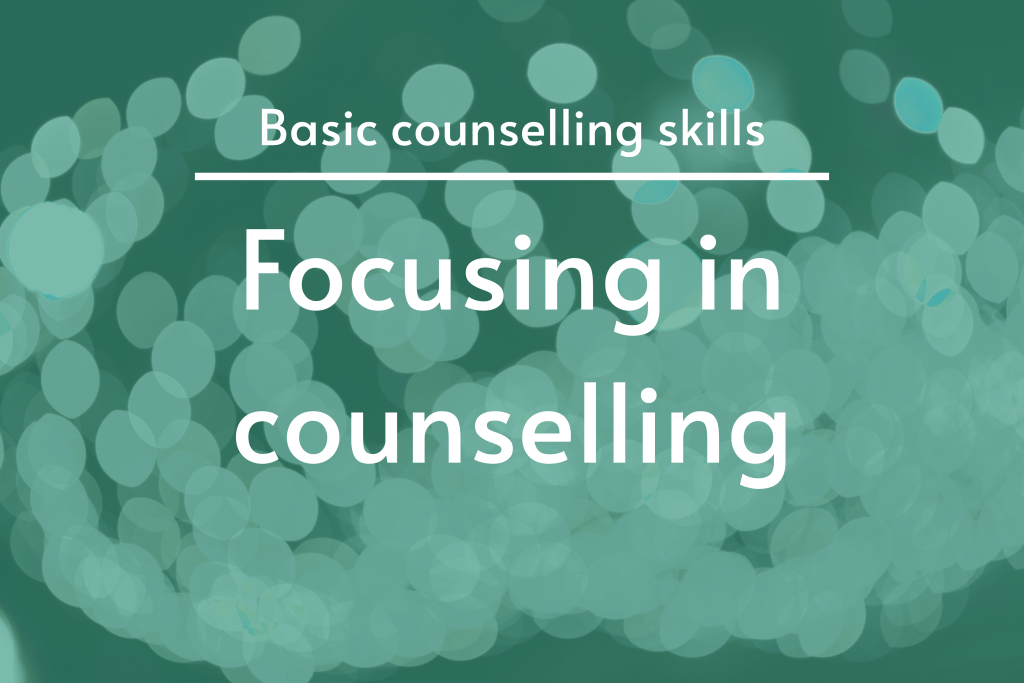 Focusing in counselling featured image. The image shows the article title on an out of focus lighting and turquoise faded background.